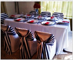 Navy Blue and White stripe.  White table cloths. Non-stretch chair covers.  Tiebacks and Runners